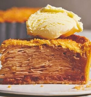 plant based apple pie with vegan flaky crust topped with vegan cream or ice cream for plant-based classic USA recipes