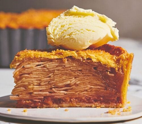 plant based apple pie with vegan flaky crust topped with vegan cream or ice cream for plant-based classic USA recipes