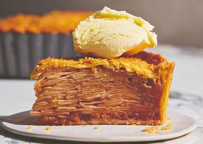 plant based apple pie with vegan flaky crust topped with vegan cream or ice cream for plant-based classic USA recipes