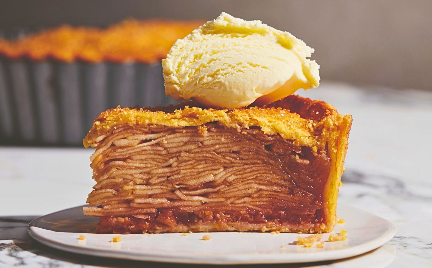plant based apple pie with vegan flaky crust topped with vegan cream or ice cream for plant-based classic USA recipes