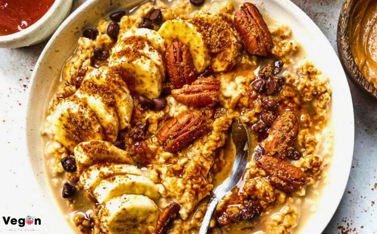 a bowl of banana, walnut and chocolate porridge with nutty drizzle and vegan protein powder