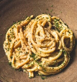 vegan Cacio e Pepe pasta with bucatini, nutritional yeast, cashews, lemon, and pepper
