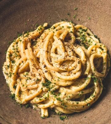 vegan Cacio e Pepe pasta with bucatini, nutritional yeast, cashews, lemon, and pepper