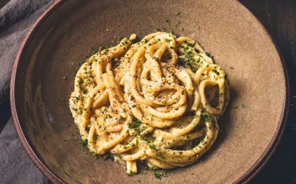 vegan Cacio e Pepe pasta with bucatini, nutritional yeast, cashews, lemon, and pepper