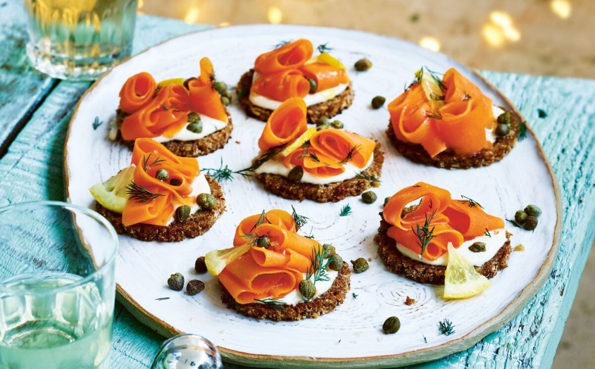 carrot lox with cream cheese canapés on little pieces of bread on a plate