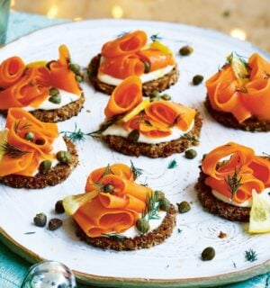carrot lox with cream cheese canapés on little pieces of bread on a plate