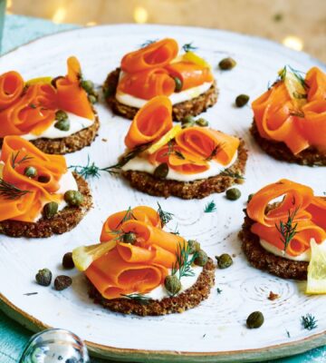 carrot lox with cream cheese canapés on little pieces of bread on a plate