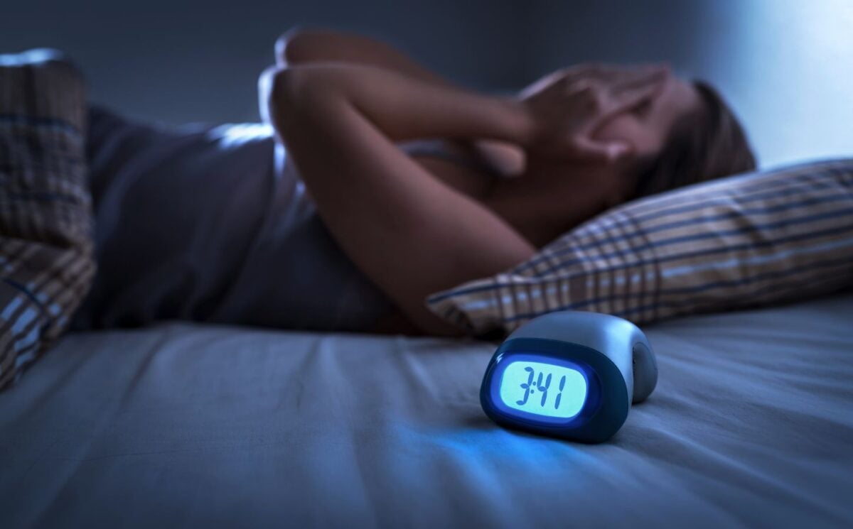 a woman struggling with insomnia relating to the link between diet and sleep