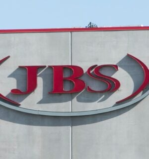 Photo shows the JBS logo in red on the front of a large grey building. JBS is launching a new plant-based collective
