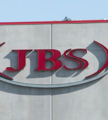 Photo shows the JBS logo in red on the front of a large grey building. JBS is launching a new plant-based collective