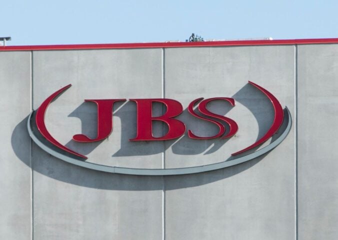 Photo shows the JBS logo in red on the front of a large grey building. JBS is launching a new plant-based collective