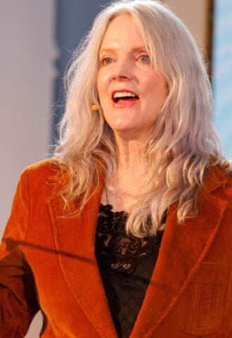 Photo shows Maggie Baird, founder of plant-based food advocacy nonprofit Support + Feed, speaking at the annual Captain Planet Foundation Gala in Atlanta earlier this year