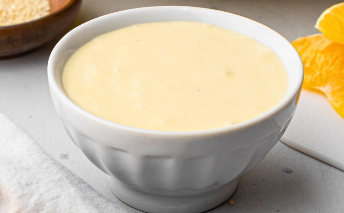 A tub of oil-free orange sesame dressing made with a vegan recipe for homemade dressings, sauces, and condiments