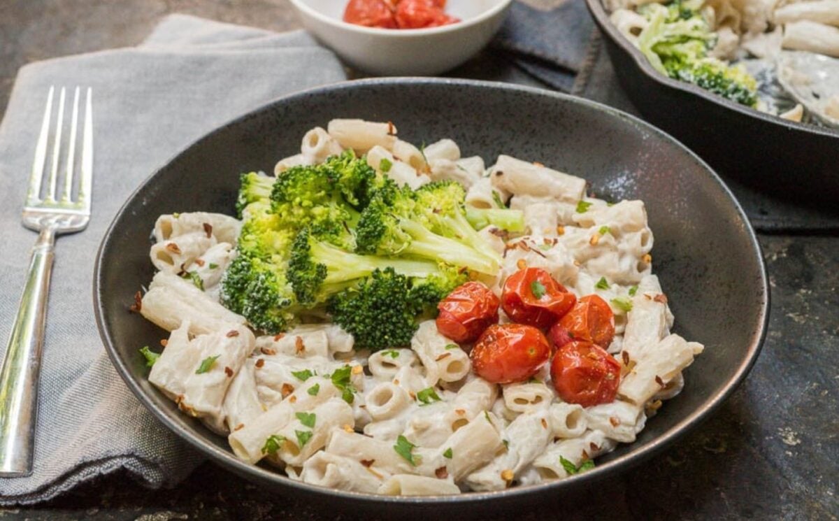a bowl plant based alfredo sauce made with cashews and miso, served with pasta