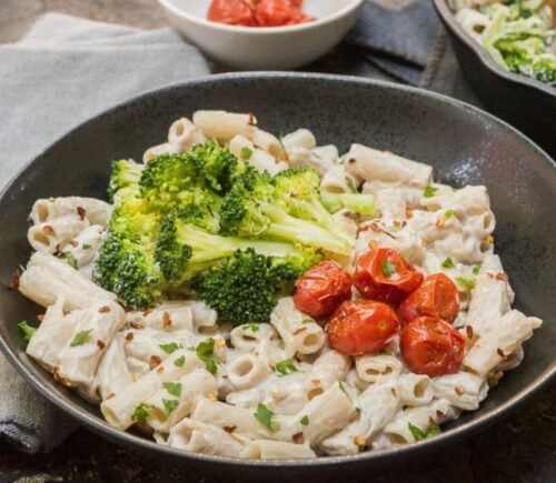 a bowl plant based alfredo sauce made with cashews and miso, served with pasta