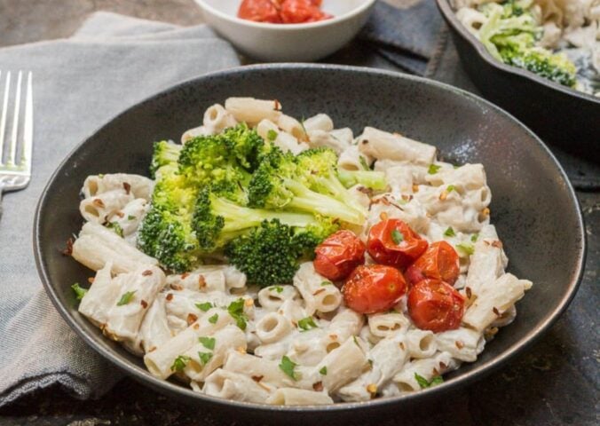 a bowl plant based alfredo sauce made with cashews and miso, served with pasta
