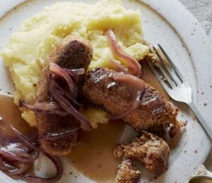 vegan sausage and mash made of walnuts, bread, and onions, served with creamy mash