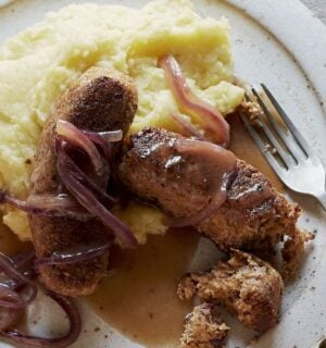 vegan sausage and mash made of walnuts, bread, and onions, served with creamy mash