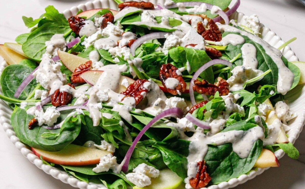 A spinach arugula salad with candies pecans and apples for early fall recipes with apples