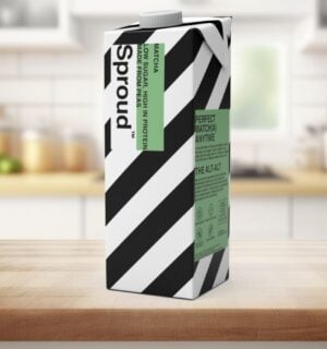 Photo shows a carton of Sproud's new matcha-flavored pea milk on a background featuring a kitchen worktop
