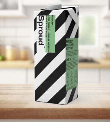 Photo shows a carton of Sproud's new matcha-flavored pea milk on a background featuring a kitchen worktop