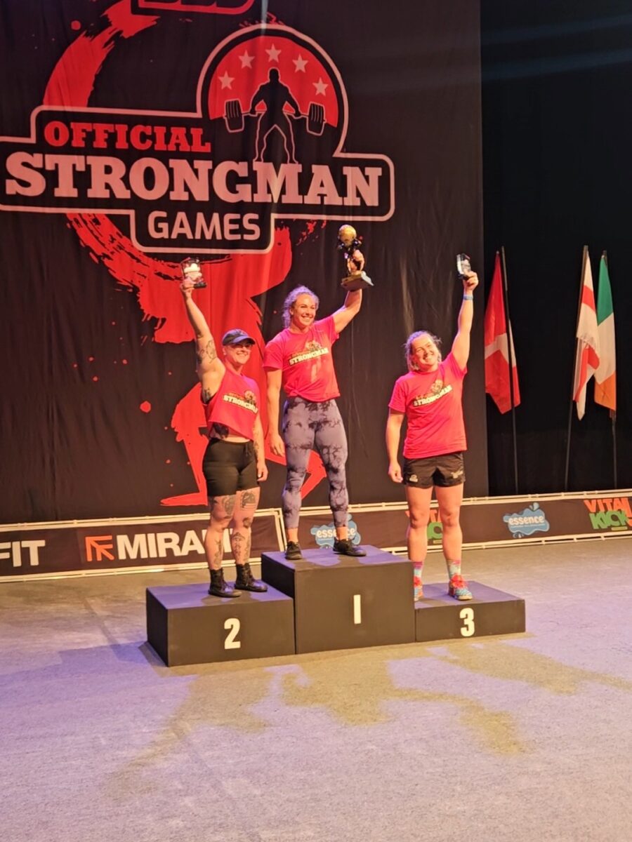 Photo shows vegan athlete Angeline Berva on the finishers' podium at the the European Strongman Games alongside her competitors