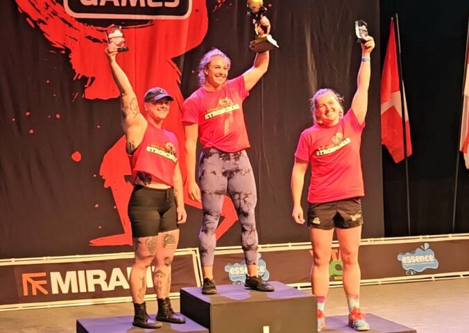 Photo shows vegan athlete Angeline Berva on the finishers' podium at the the European Strongman Games alongside her competitors