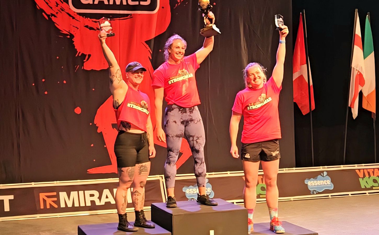 Photo shows vegan athlete Angeline Berva on the finishers' podium at the the European Strongman Games alongside her competitors