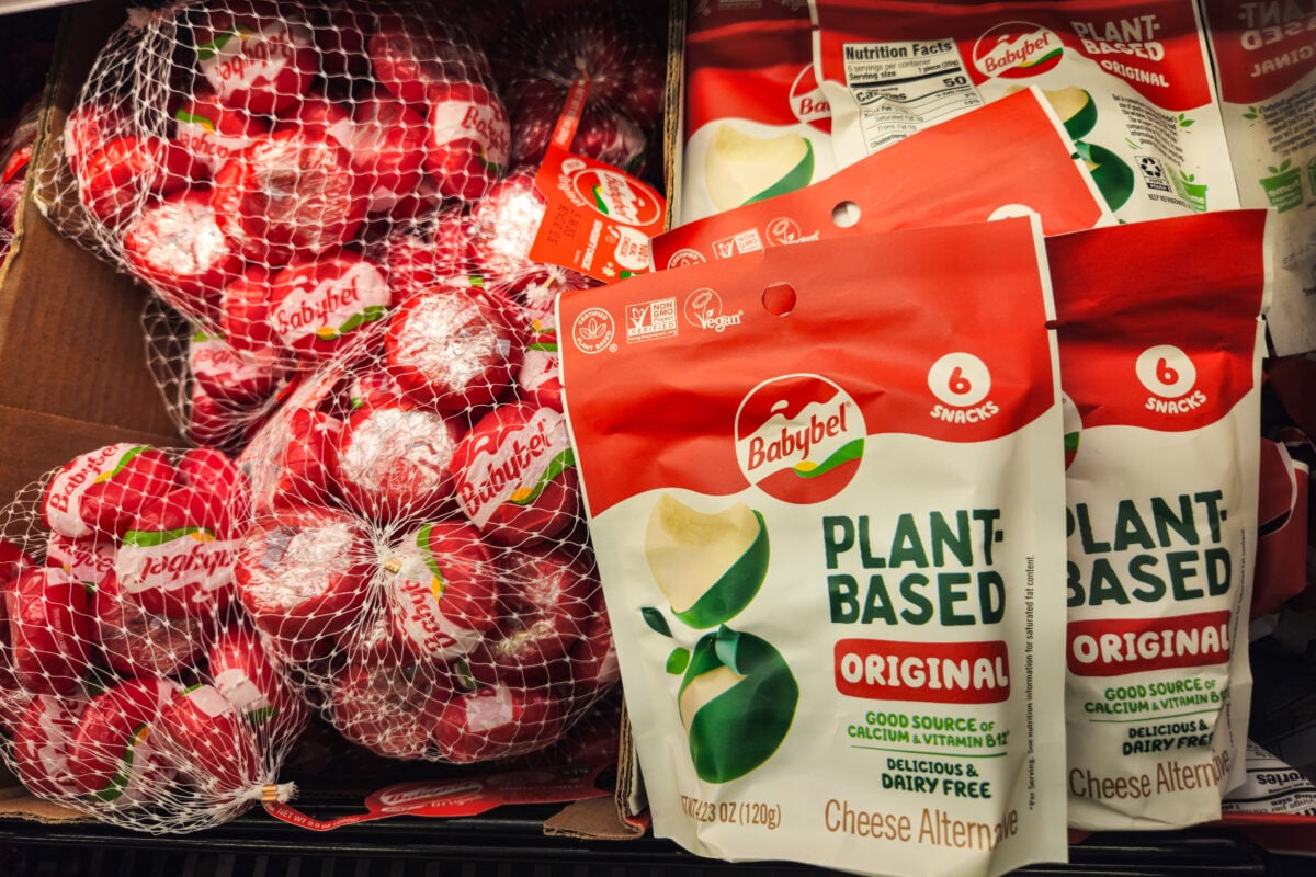 Photo shows a selection of classic Babybel cheeses (left) and a packet of the Original plant-based version (right)