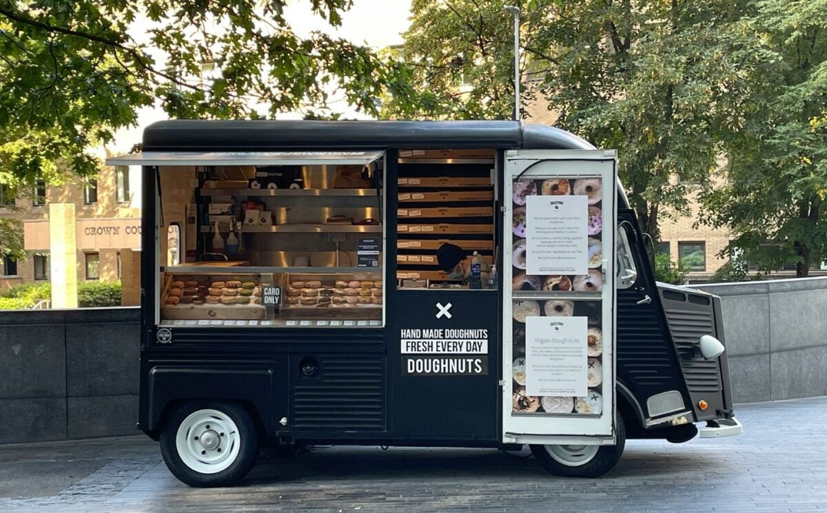 Photo shows a small doughnut van - here's how to start a vegan food truck