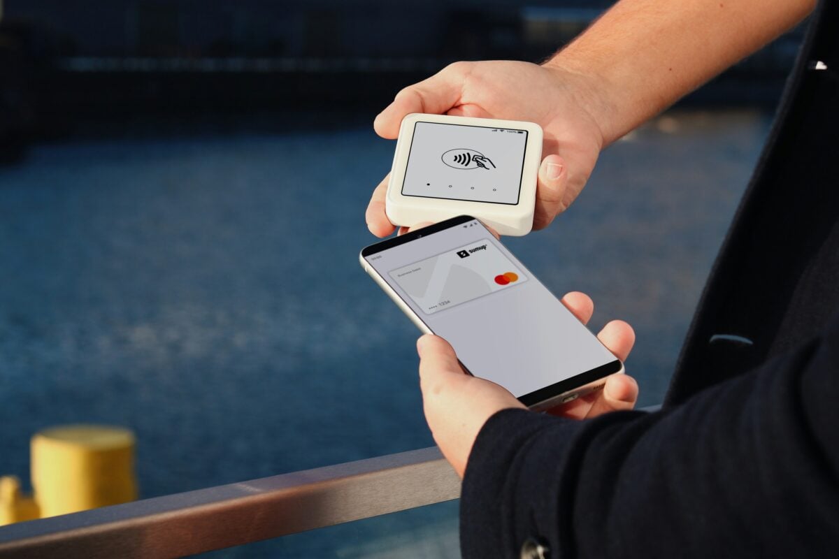 Photo shows someone paying for something using SumUp