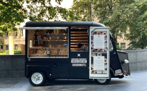 Photo shows a small doughnut van - here's how to start a vegan food truck