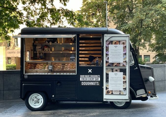 Photo shows a small doughnut van - here's how to start a vegan food truck