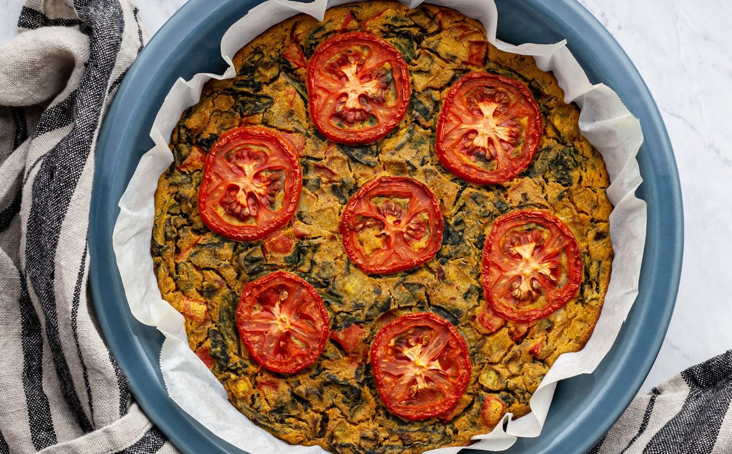 vegan gluten-free quiche florentine with nutritional yeast, veggies, and spices