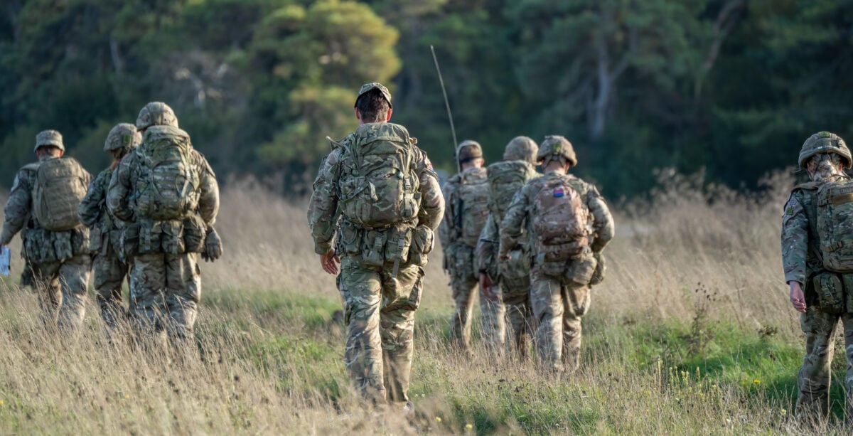 Photo shows a group of soldiers walking together on exercise