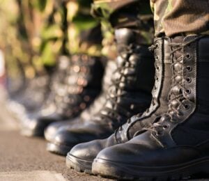 Photo shows the boots of soldiers standing in a row at attention. Britain's RAF soldiers will now have access to vegan uniforms