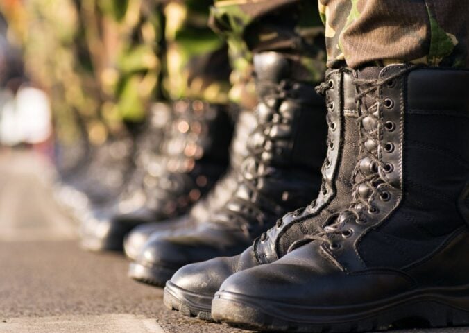 Photo shows the boots of soldiers standing in a row at attention. Britain's RAF soldiers will now have access to vegan uniforms