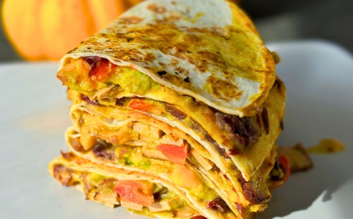 a stack of 15-minute quesadillas with pumpkin cheese, refried beans, and tofu