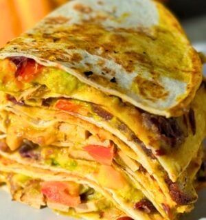 a stack of 15-minute quesadillas with pumpkin cheese, refried beans, and tofu