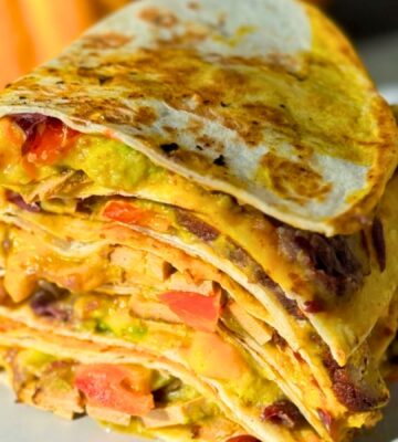 a stack of 15-minute quesadillas with pumpkin cheese, refried beans, and tofu
