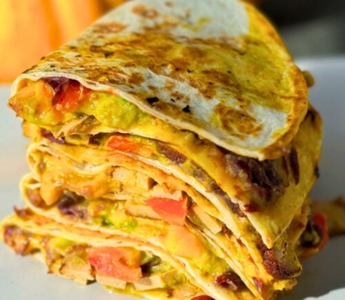 a stack of 15-minute quesadillas with pumpkin cheese, refried beans, and tofu