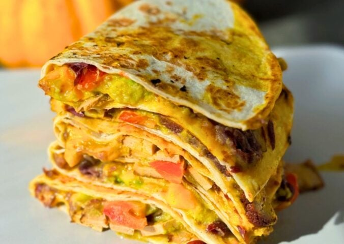 a stack of 15-minute quesadillas with pumpkin cheese, refried beans, and tofu