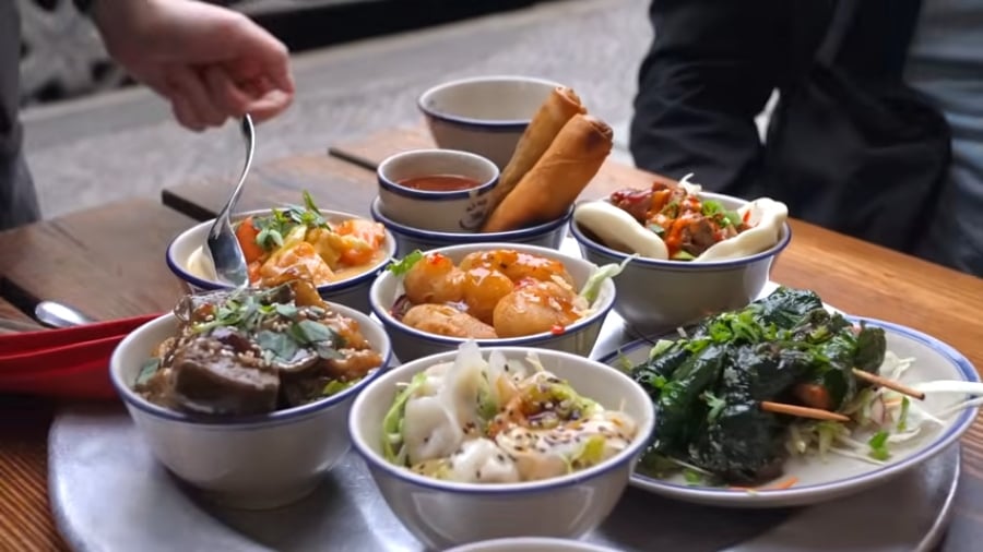 A spread of vegan Vietnamese dishes including lot leaves, bao buns, and lemongrass curry at one of Eunice Reyes’ stops for vegan food in Berlin