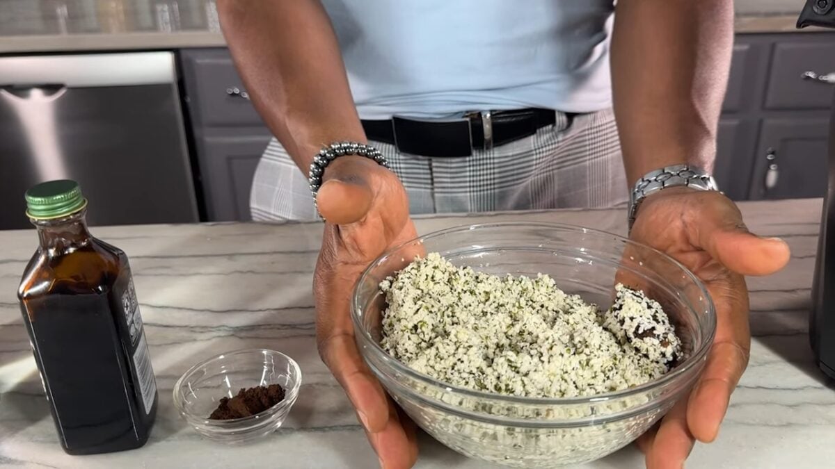 Javant holds a bowl of soaked hemp seeds next to a small bowl of vanilla bean powder, key ingredients for making homemade vanilla hemp milk.