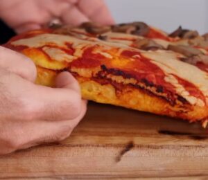 Freshly baked vegan pizza made with sweet potato pizza dough, topped with cashew cheese and mushrooms