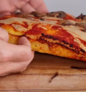 Freshly baked vegan pizza made with sweet potato pizza dough, topped with cashew cheese and mushrooms