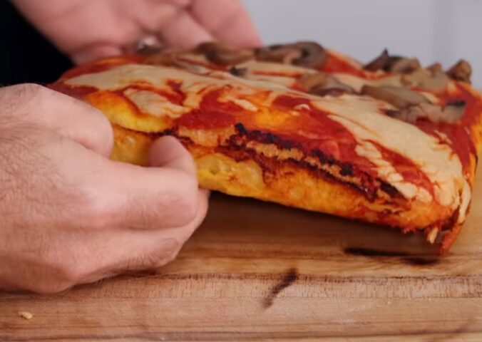 Freshly baked vegan pizza made with sweet potato pizza dough, topped with cashew cheese and mushrooms