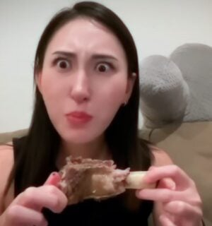 Perfect Carnivore influencer Steak and Butter Gal eating meat off a bone, promoting her meat-only diet