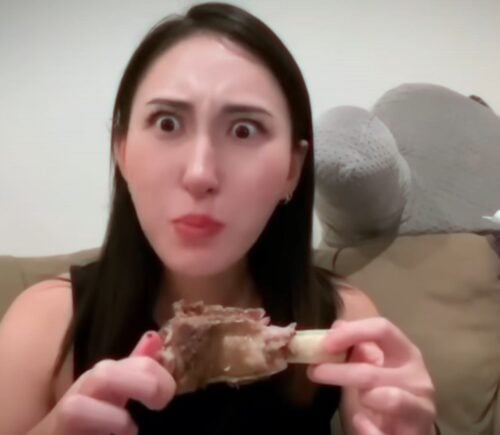 Perfect Carnivore influencer Steak and Butter Gal eating meat off a bone, promoting her meat-only diet