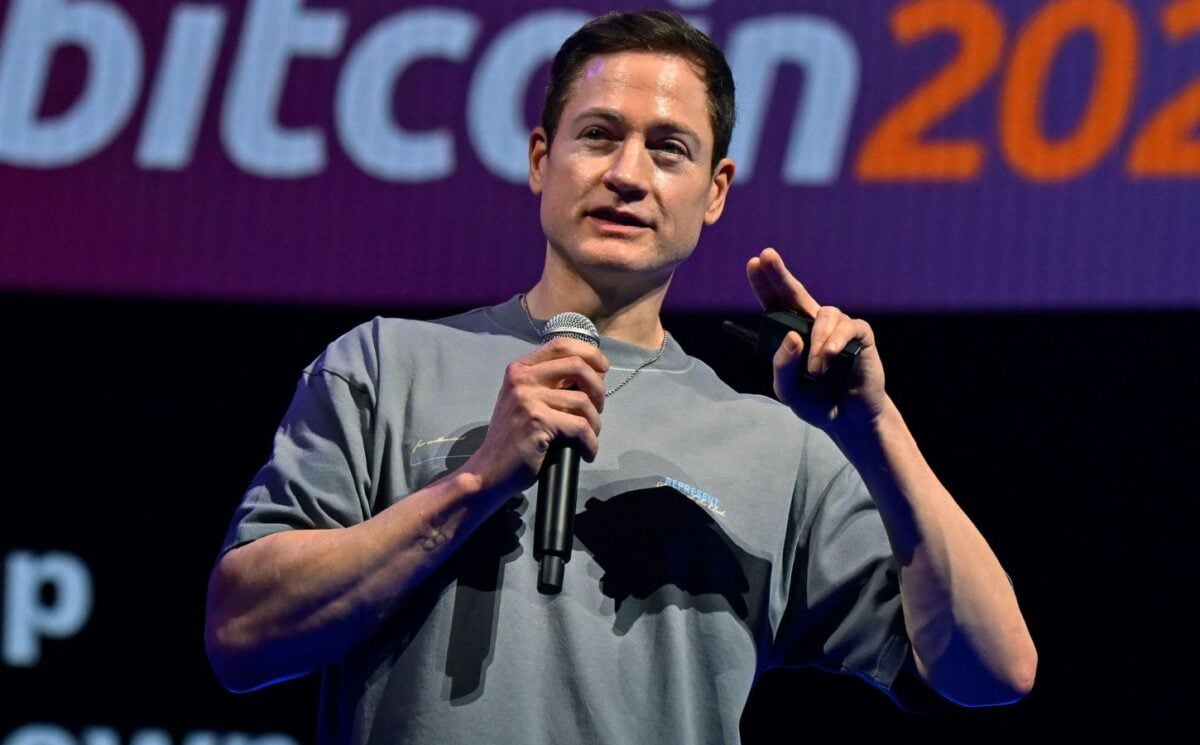 Photo shows longevity influencer Bryan Johnson speaking at a Bitcoin event earlier this year